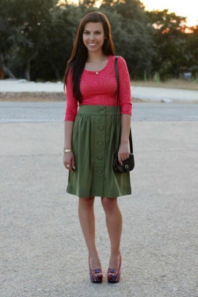 Orange fitted lace top with half sleeves and green knee length
skirt