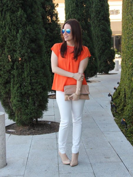 orange short-sleeved blouse with white slim-fit jeans