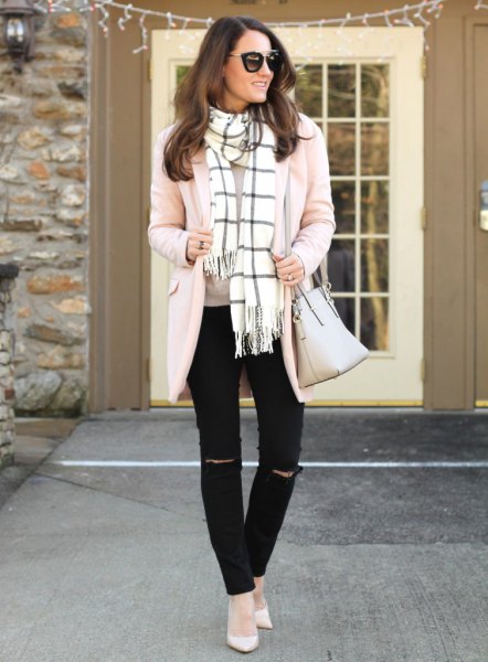 Pale pink cardigan with a white and black checked fringe
scarf