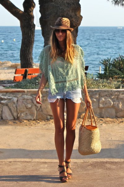 pale pink crochet top with mini denim shorts and beach straw bag