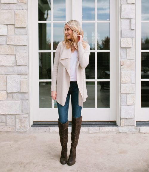 Light pink long waterfall cardigan with white tank top and black knee high boots