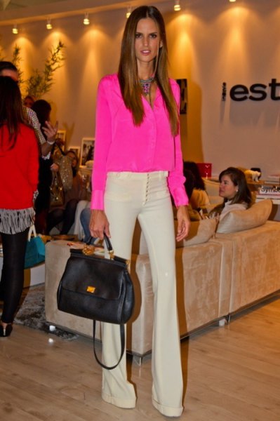 Pink chiffon blouse with buttons and light yellow flared trousers