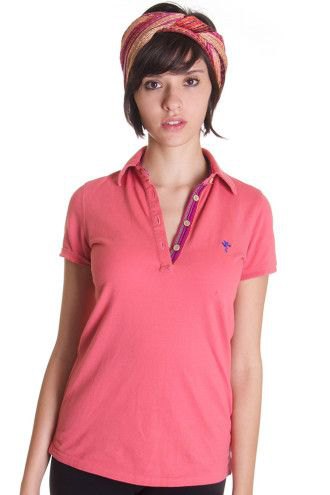 Pink polo shirt with blush headband and dark jeans