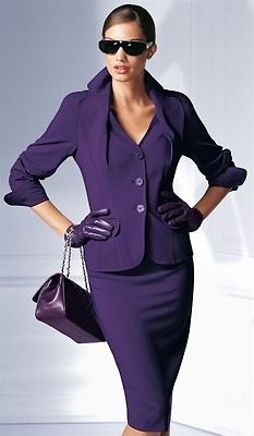 Lilac skirt suit with black leather handbag