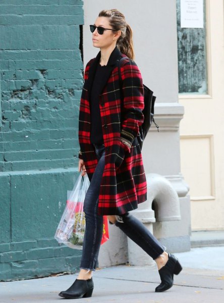 Midi length red and black plaid coat with dark blue ankle skinny jeans