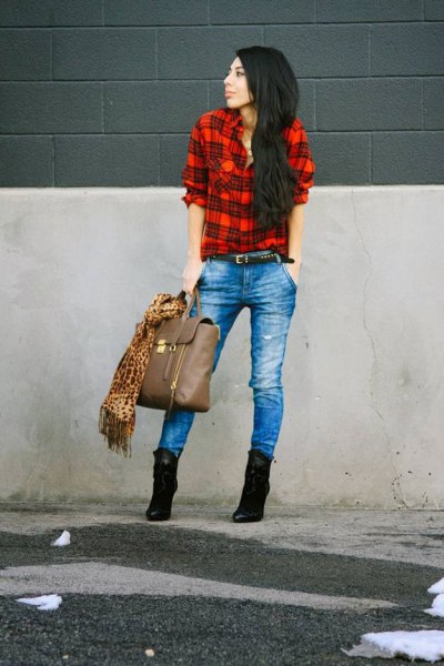 red and black shirt with blue jeans and suede heeled ankle boots