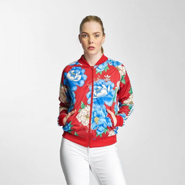 Red and blue floral sports jacket and white jeans