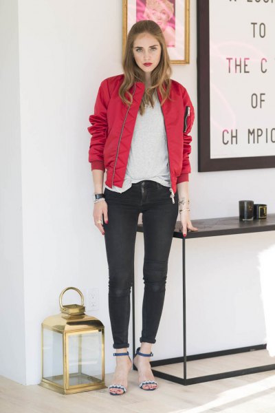 Red bomber jacket with white t-shirt and black cuffed skinny jeans