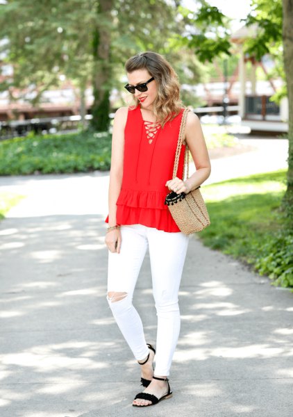 Red sleeveless blouse with crossed V-neck in front and white ripped
jeans