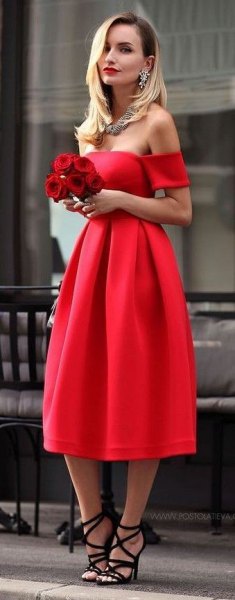 Red strapless flared midi dress with black strappy heeled sandals