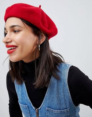 Red painter's hat with a black stand-up collar sweater and a blue V-neck denim dress