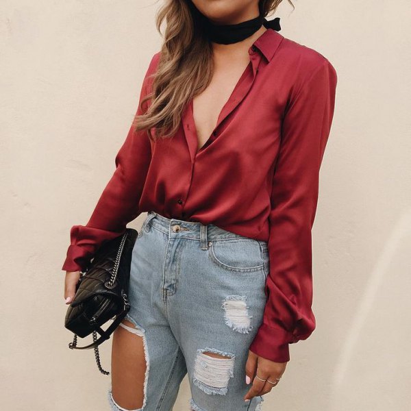 red satin shirt with black collar and ripped jeans