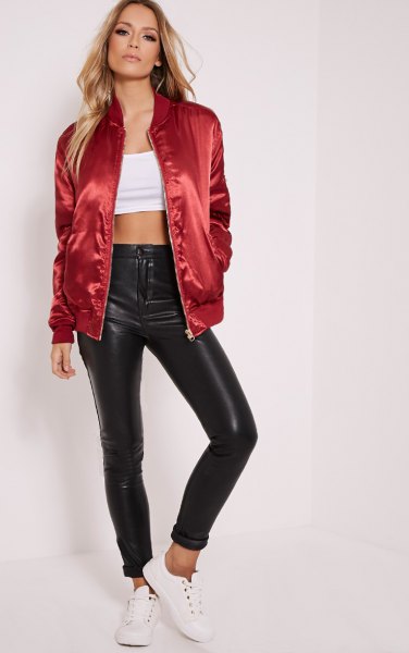 Red shiny oversized bomber jacket with white crop top and leather pants