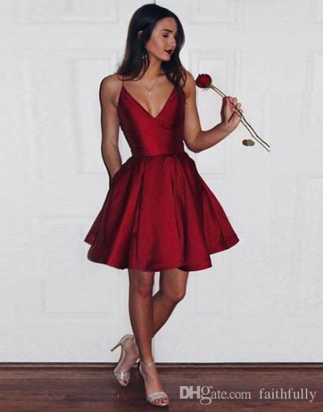 Red silk mini dress with deep V-neckline and flared cut and pink heels