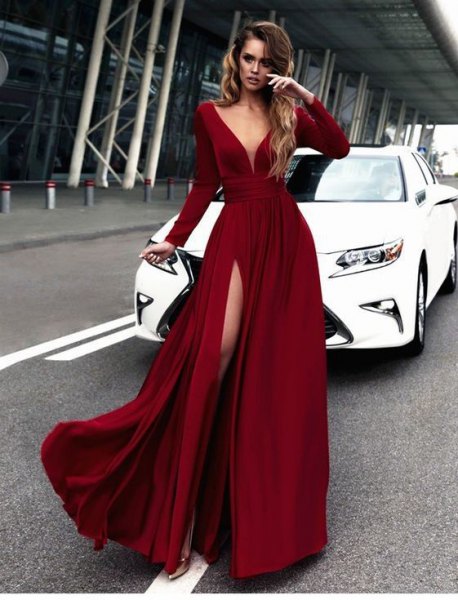 Flowing red silk dress with a deep V-neckline and long sleeves