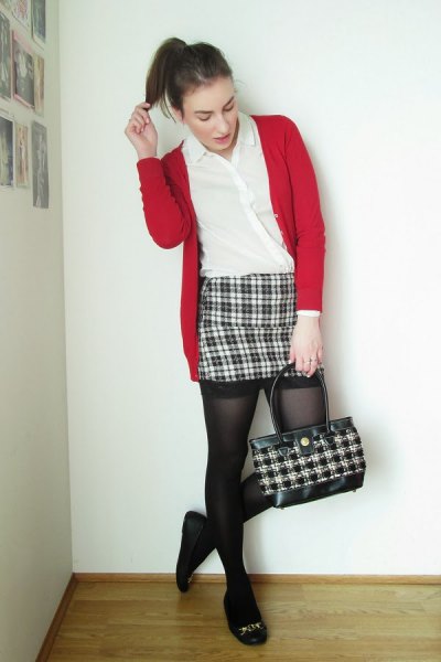 Red sweater cardigan with a black and white checked mini skirt