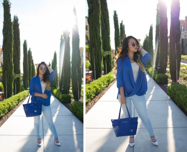 Royal blue leather handbag with matching draped top and white jeans