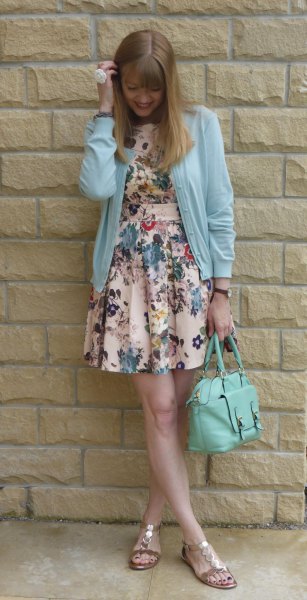 Sky blue cardigan with floral printed mini swing dress and golden sandals