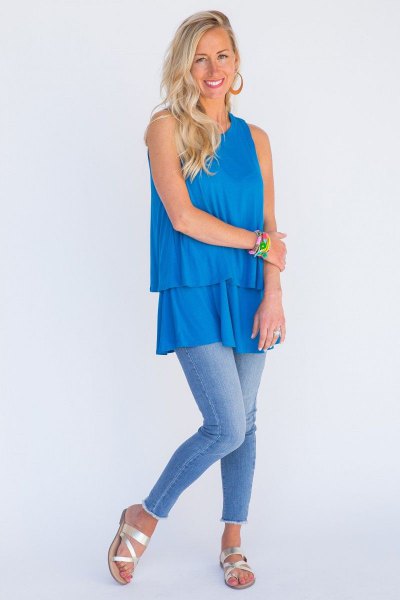 Sky blue tunic top with a ruffled hem and skinny jeans