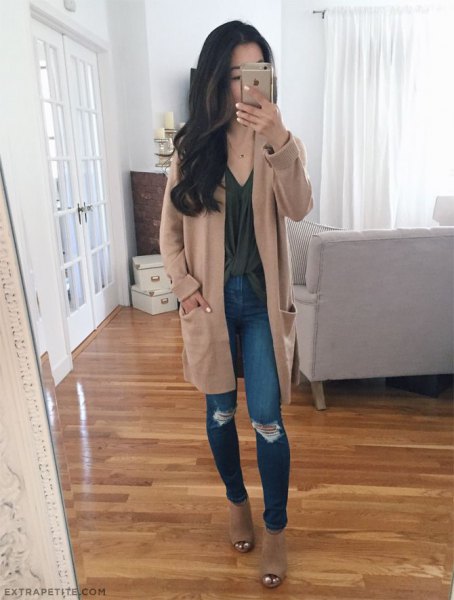 Light brown long sweater cardigan with blue skinny jeans with ripped knees