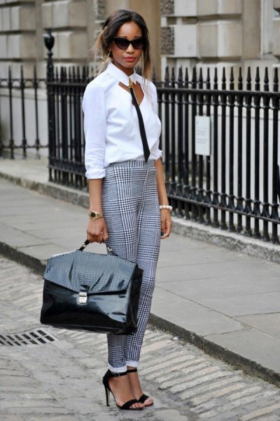 White and black blouse with cut outs at front and checked chinos