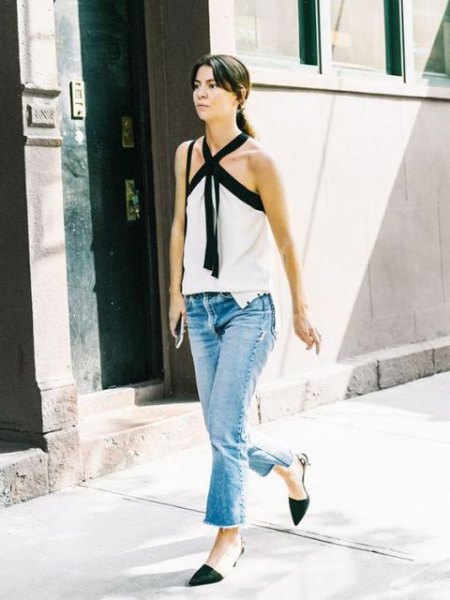 White and black halter top with flared jeans and kitten heel pumps