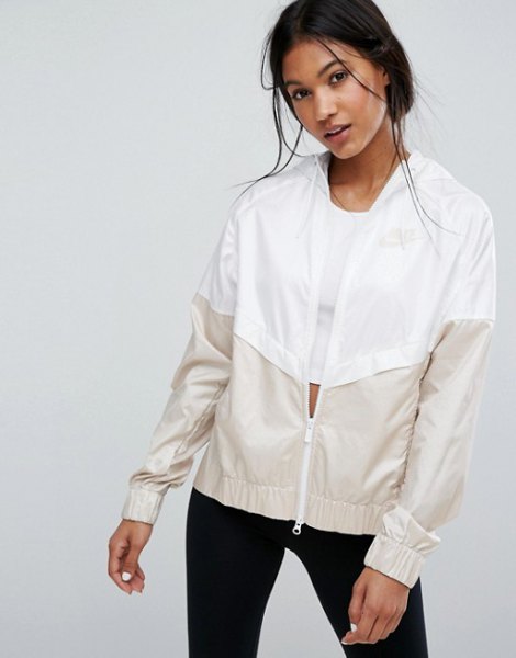 White and light pink color block windbreaker with black skinny jeans
