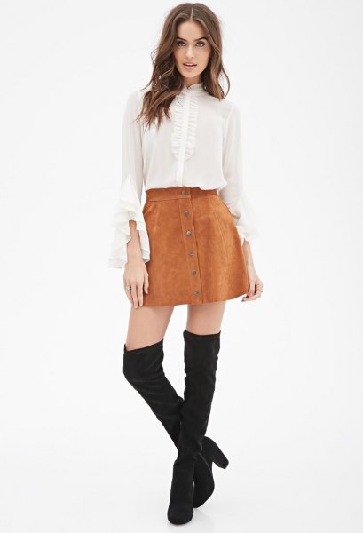 White chiffon blouse with bell sleeves, mini suede skirt and thigh high boots