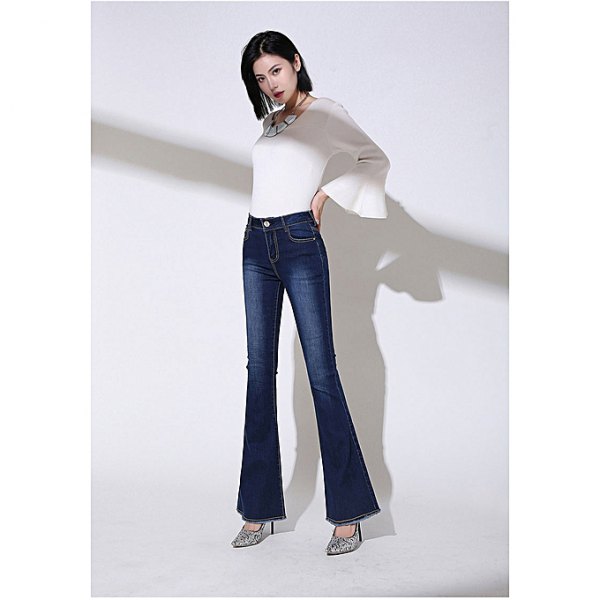 White bell sleeve top and navy blue high-rise jeans with flared pants