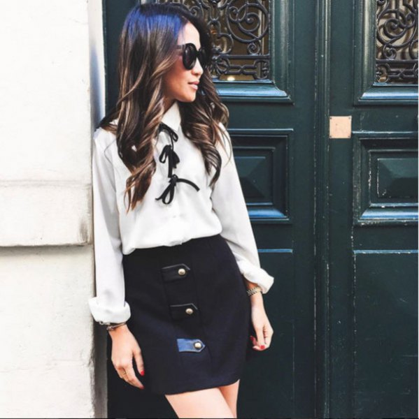 White blouse with bow tie and black high waist mini skirt