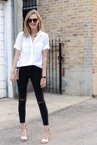 White button down blouse and black ripped ankle length jeans