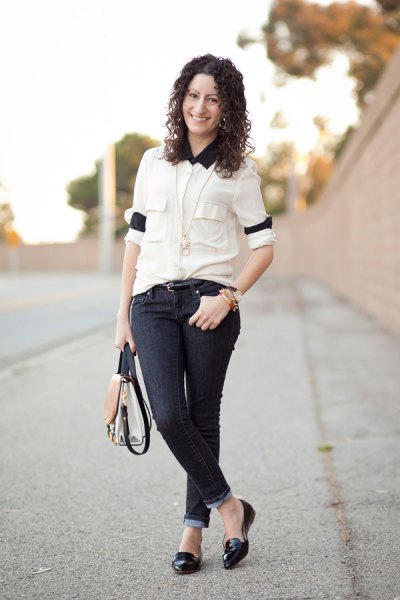 White button down shirt with black collar and cuffed dark skinny jeans
