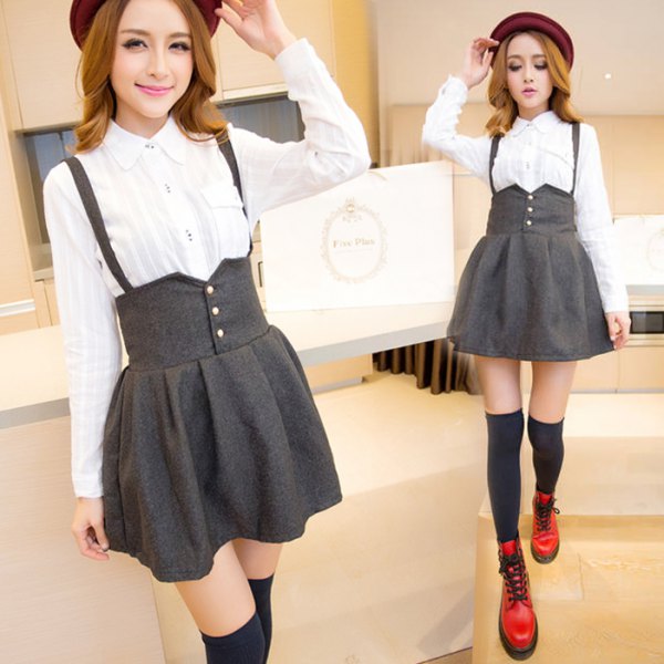 White button down shirt and gray high waisted suspender skirt