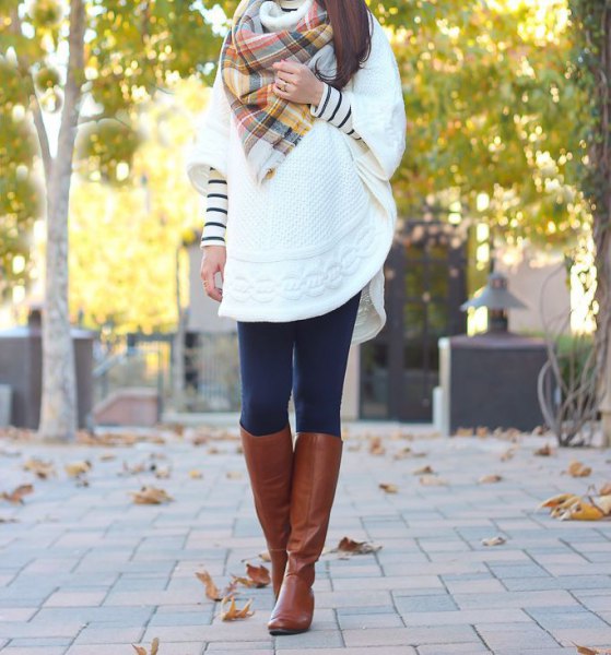 white cable knit cape with plaid scarf and brown knee high leather
boots