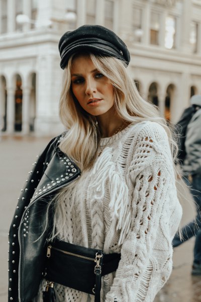 White chunky cable knit jumper, studded motorcycle jacket and leather painter's hat