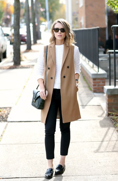 White cable knit sweater with pink sleeveless wool coat and loafers