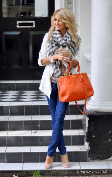 white casual blazer with gray checked scarf and orange leather handbag