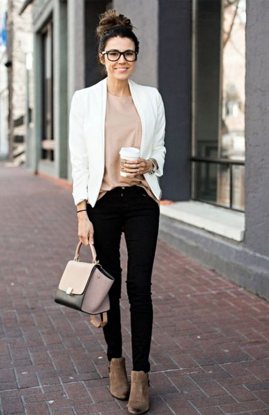 White casual blazer with a pink top and black skinny jeans