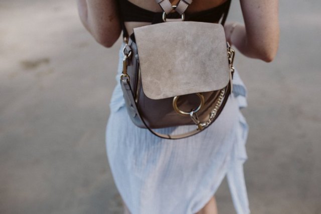 White chiffon airy mini dress with gray suede backpack handbag