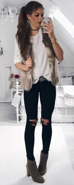 This is paired with a white comfy sweater paired with black ripped jeans and gray heeled boots