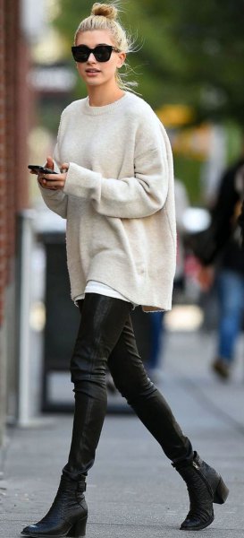 White chunky crew neck sweater and black leather pants