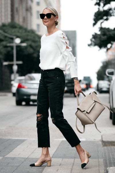 Pair a white crew-neck sweater with black ripped boyfriend jeans
