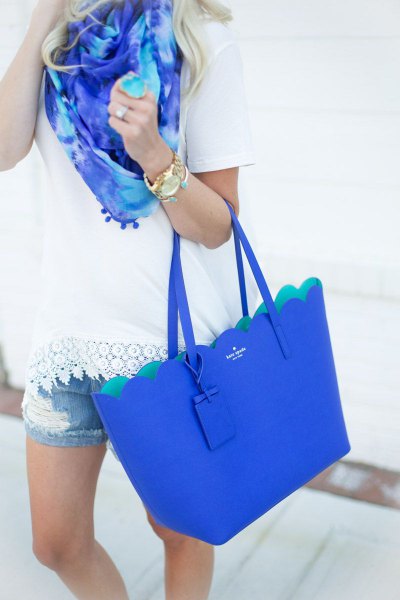 White t-shirt with crochet hem, denim shorts and royal blue handbag