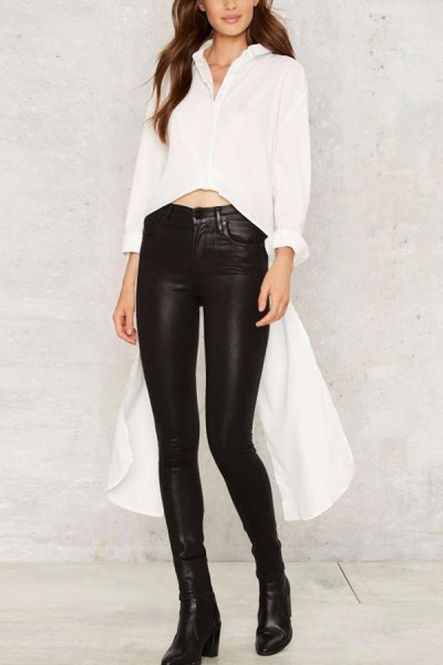 White cropped high-low blouse paired with high-waisted black leather leggings