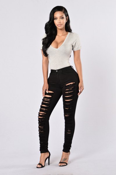White deep V-neck bodycon t-shirt with heavily ripped skinny jeans