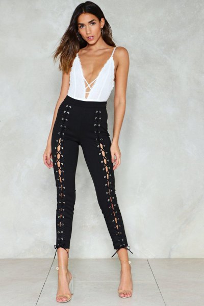 White deep V-neck top and black tight lace-up pants