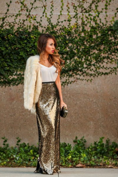White faux fur coat with tank top and gold sequin maxi skirt