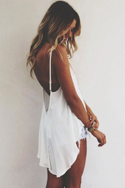 White flowy backless high low tank top with denim shorts