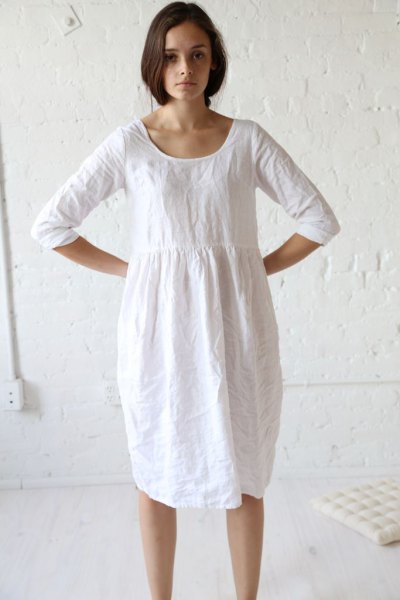 White linen tunic dress with gathered waist and sneakers