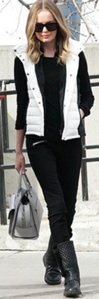 White hooded down vest, black sweater and jeans